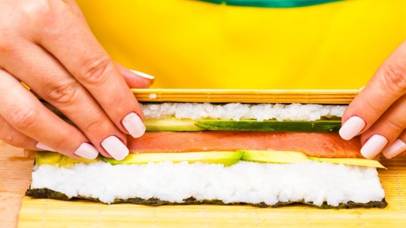 rolling sushi on mat